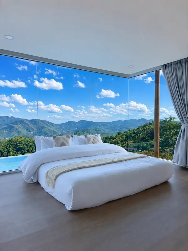 Glass-walled bedroom with a panoramic view