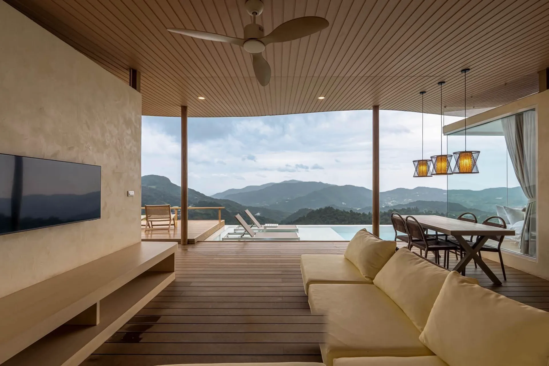 Living room with Smart TV and dining table facing the mountains